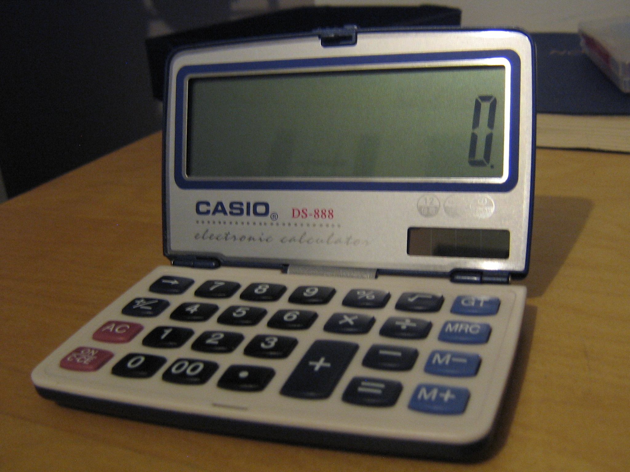 a calculator which folds open and closed, currently in its opened state.